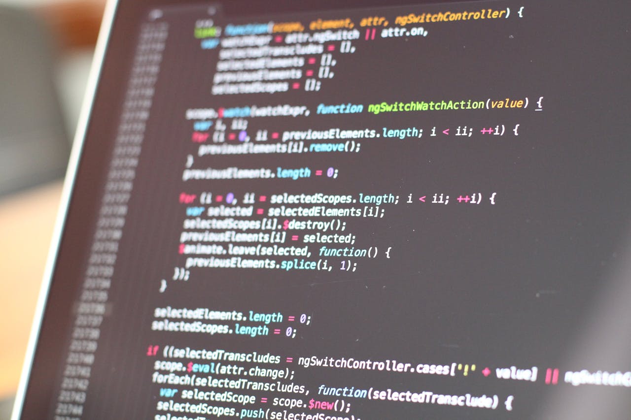 Home Close-up view of colorful code on a laptop screen, showcasing programming concepts.